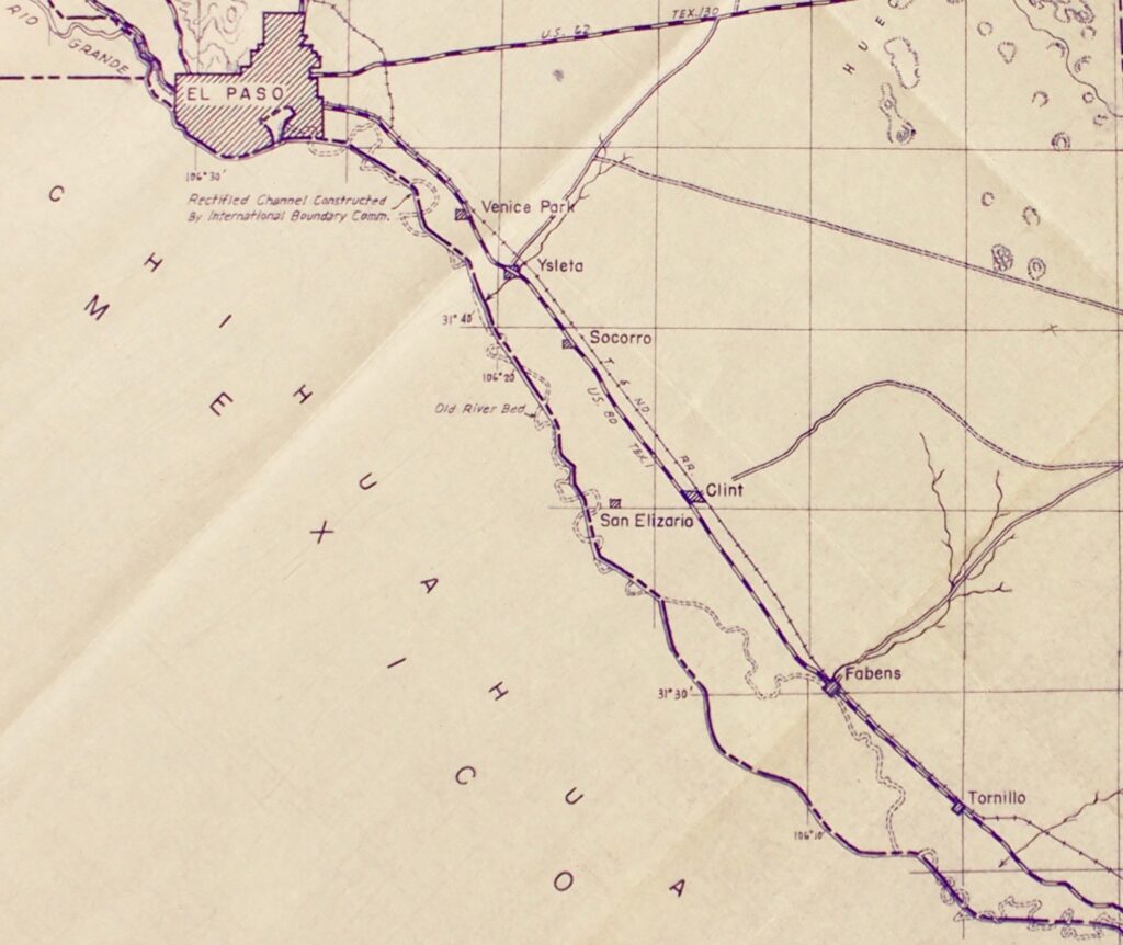 Detail of a map in dark purple print on white-beige paper. On the left, Chihuahua, Mexico is written in capital letters. El Paso is shown, and shaded with diagonal lines at the top left. Extending down in a diagonal toward the bottom right is the winding Rio Grande, alongside it a depiction of a railway line. In fainter broken lines is the outline of what used to be the river bed. Text underneath El Paso indicates that the darker line is the Rectified Channel Constructed by International Boundary Comm.