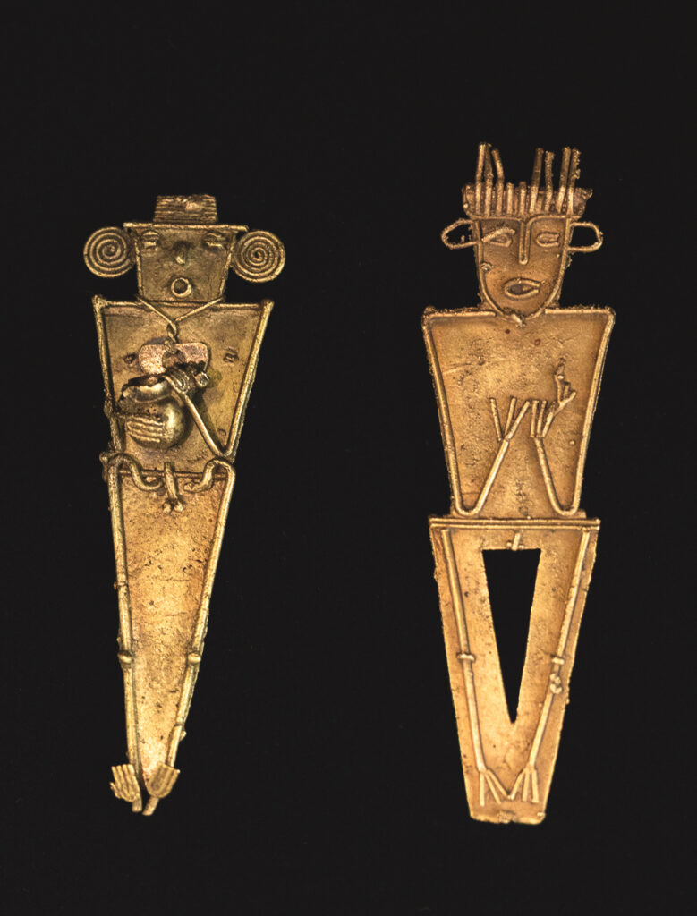 Two flat, geometrical human figures made of gold are side by side on a black background. The features are outlined in gold wire.