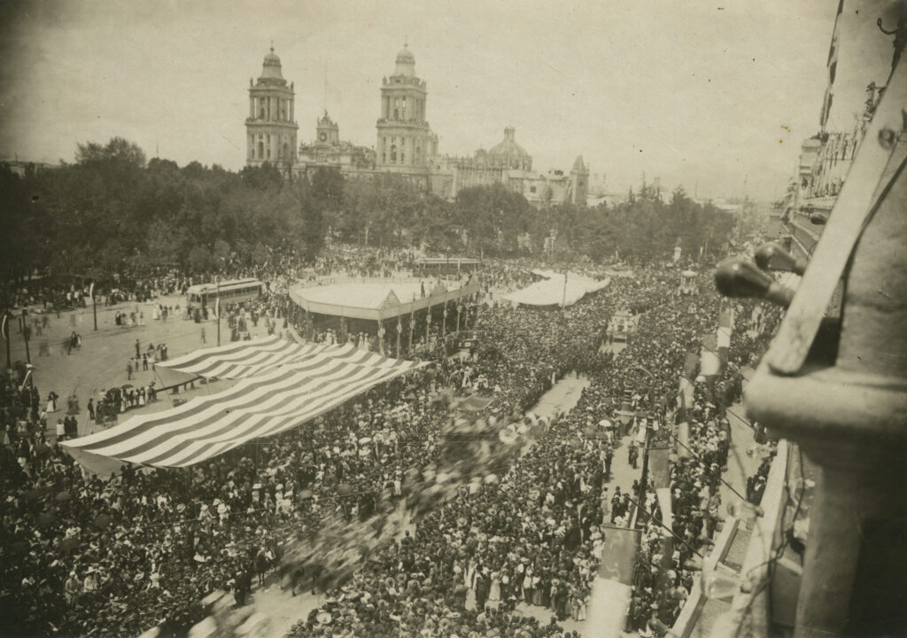 Areal view of historical parade passing through Mexico City's main plaza