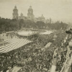 Areal view of historical parade passing through Mexico City's main plaza 