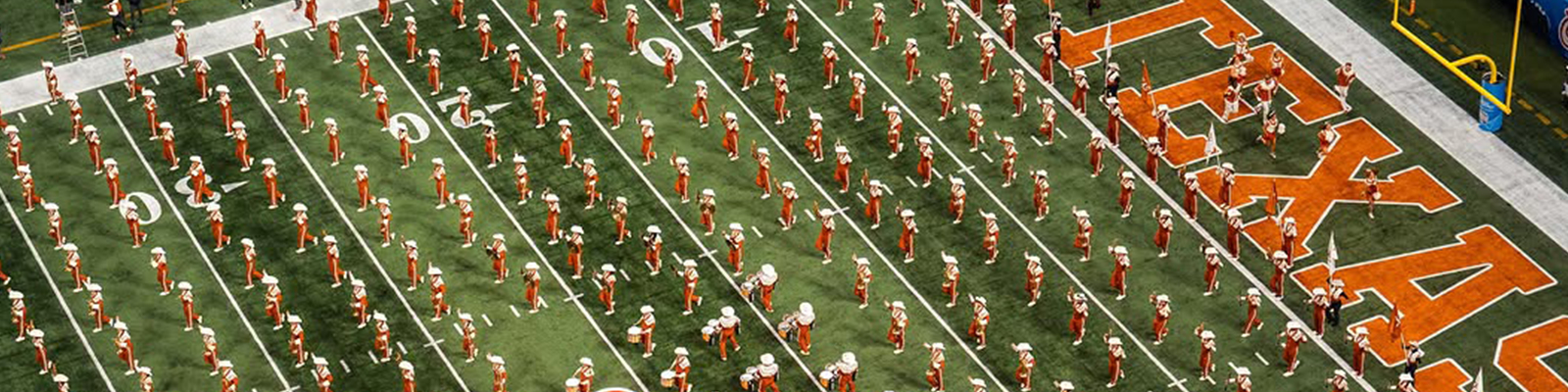 Rows of Longhorn Band members on the field