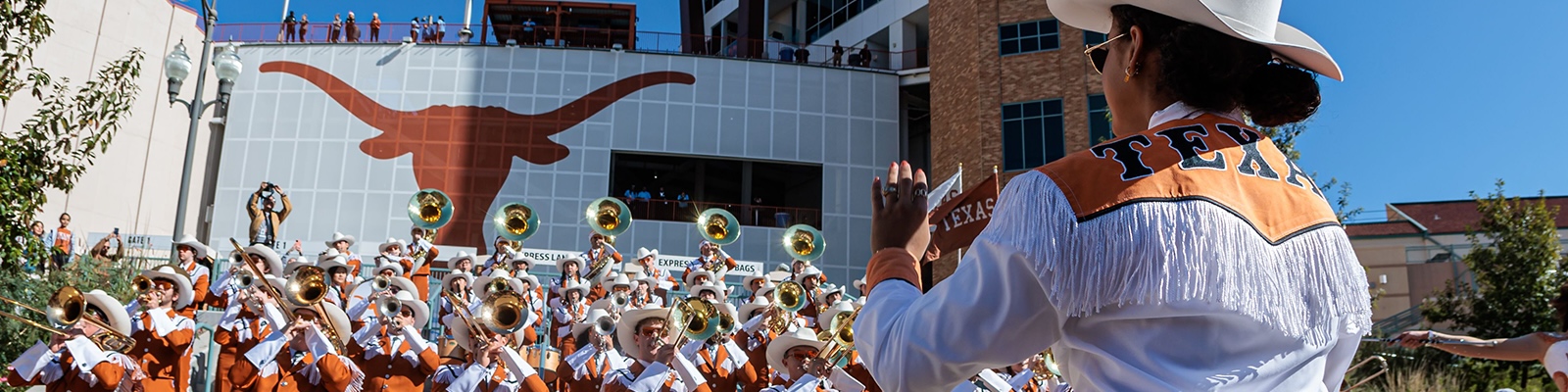 The band playing in front of a conductor 