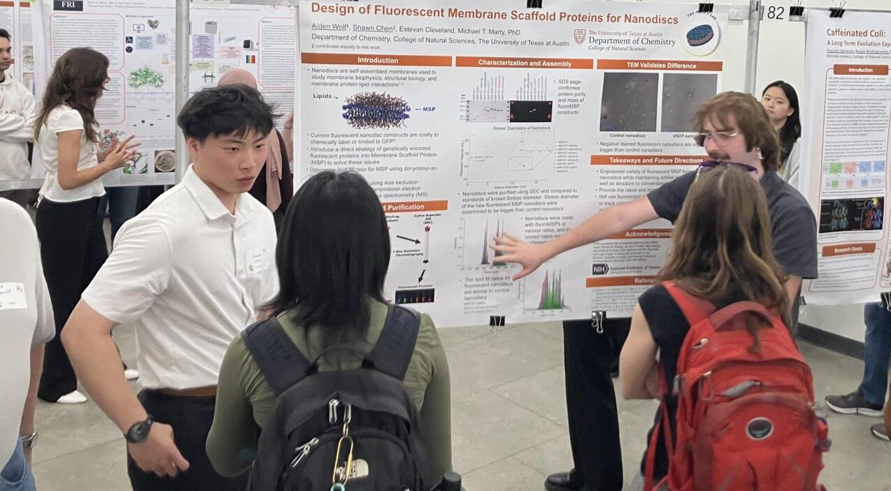 Shawn (left) and Aiden (right) explaining their poster to conference goers! 