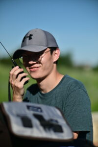 Person holding amateur radio handheld.