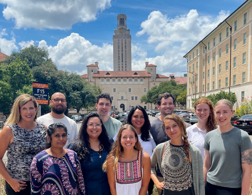 Dr. Nixon and ten lab members on UT campus with UT tower in background
