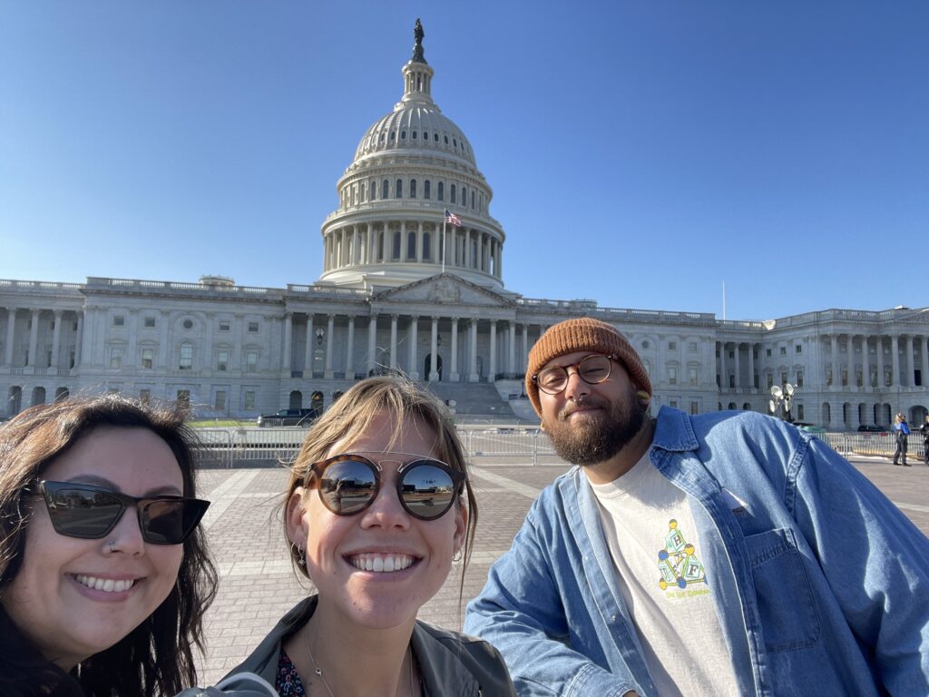 Three lab members attending the Society for Neuroscience (SfN) conference in Washington, DC and standing in front of the Capitol Building.