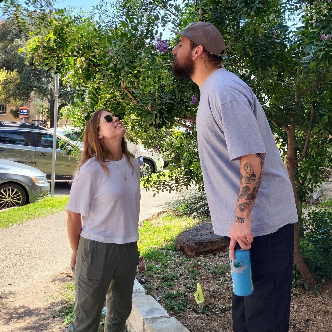 Two lab members facing each other in an outdoor setting.