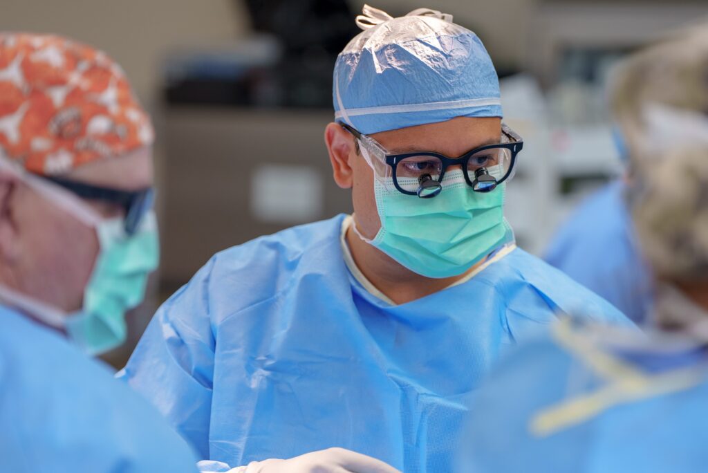 Kevin Kumar, MD, PhD, performing surgery