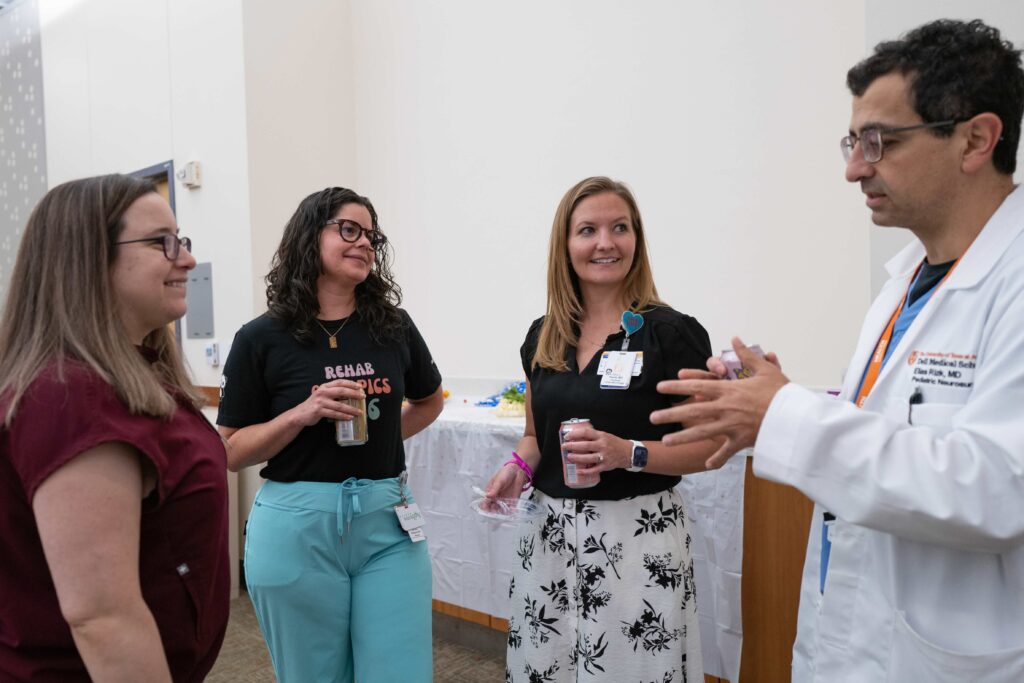 Faculty members talking at CARF celebration