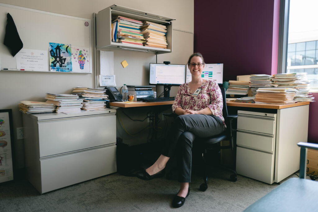 Cynthia Austin, PhD, in her Dell Children's office