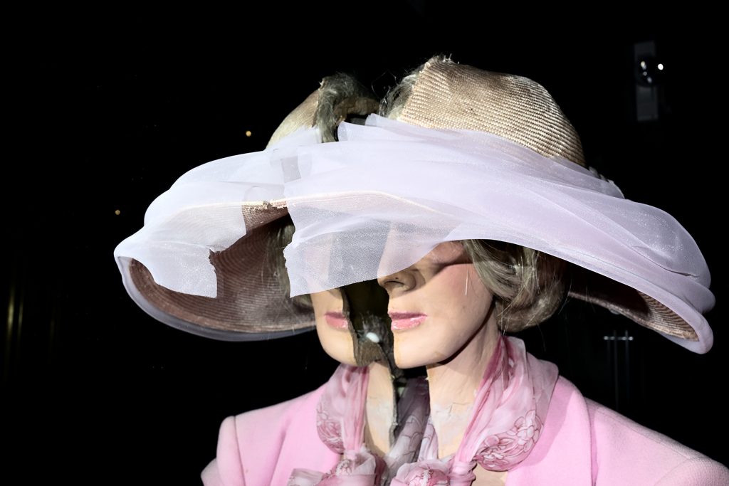 mannequin wearing pink jacket and hat split in half