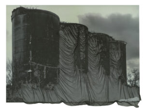 image, possibly digitally manipulated, showing what appear to be four silos wrapped in some form of textile