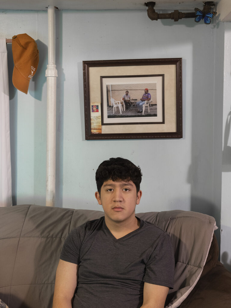 teenager sitting on couch looking toward camera