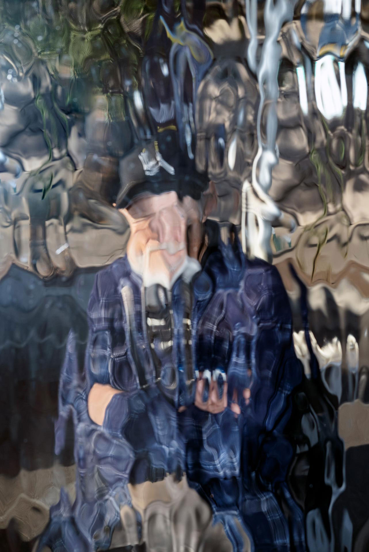 abstracted image of possible figure, shot through sheet of distorted glass