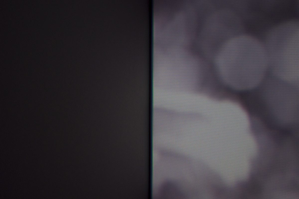 abstracted image on right, with black wall on left