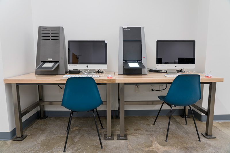 two computer stations, each with film scanners
