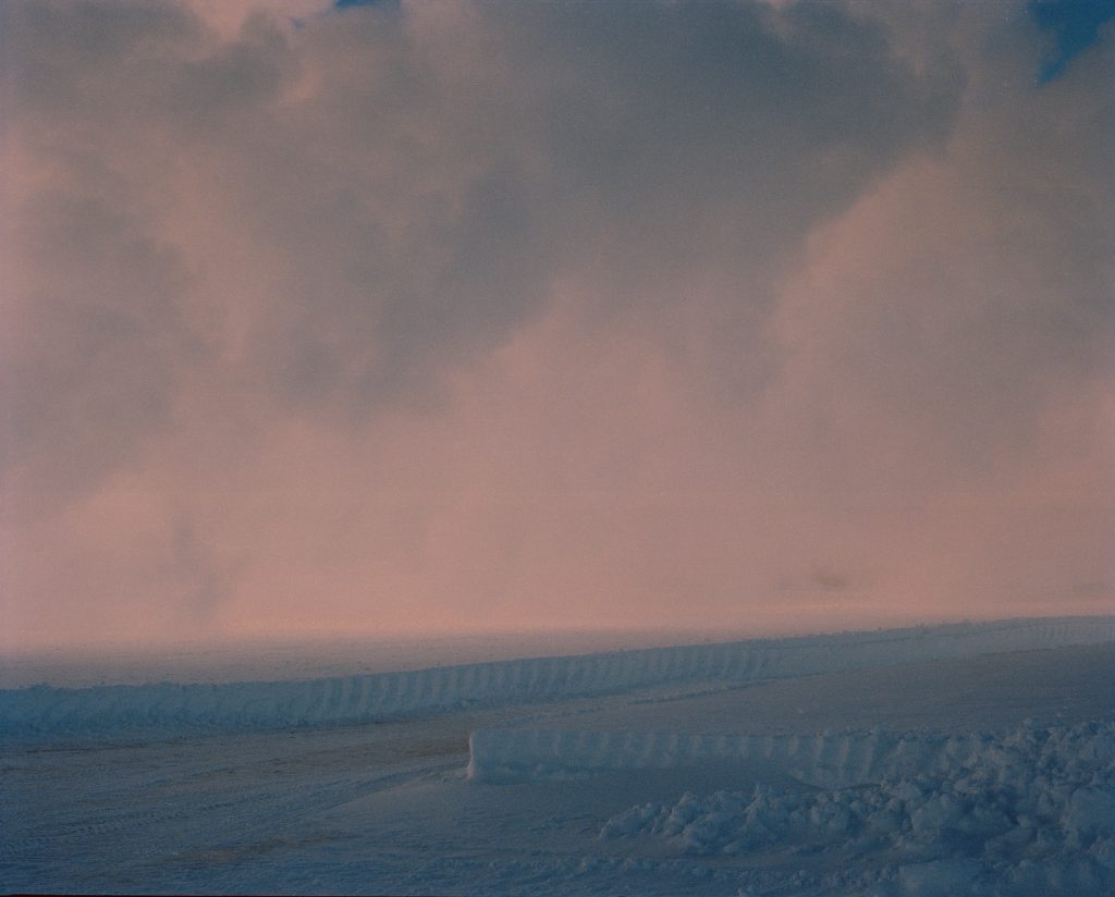 pink and blue image of what may be a beach at dawn or dusk