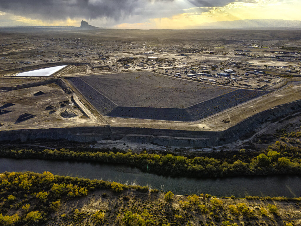 ariel image of what appears to be a large industrial sight in a desert landscape that sits adjacent to a small river