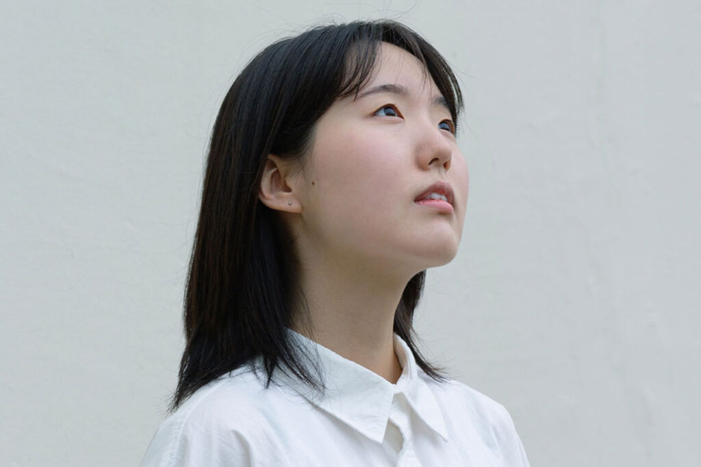 person wearing white shirt looking at something out of frame