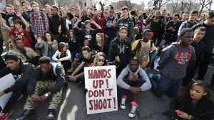 East High School students in Denver participate in a protest against the Ferguson, Missouri grand jury decision, in a busy intersection in front of the state Capitol, Wednesday Dec. 3, 2014. (AP Photo/Brennan Linsley)