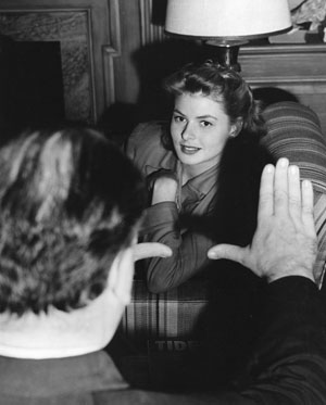 Director Alfred Hitchcock frames Ingrid Bergman in a still from the set of 'Spellbound' (1945)