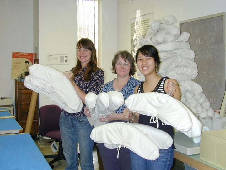 Apryl Voskamp, Mary Baughman and Liz Phan show completed hangers from the project. Photo by Olivia Primanis.