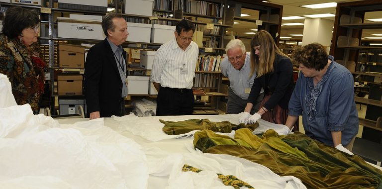 Ransom Center curators Steve Wilson (second from left) and Jill Morena (second from right) discuss construction history of the green curtain dress from ‘Gone With The Wind.’ University colleagues from Human Ecology include from left, Dr. Kay Jay, Director of the Historical Textiles and Apparel Collection; Dr. Bugao Xu, Professor in the Division of Textiles and Apparel; Dr. Sheldon Ekland-Olson, Director of the school; and Nicole Villarreal, Human Ecology graduate student. Photo by Anthony Maddaloni.