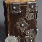 "The New Testament of Our Lord Jesus Christ" (London: Christopher Barker, 1598). The Stark Library. Early pocket-sized Bibles often benefitted from the protection of clasps and cornerpieces, which protected a volume’s edges from wear, enhancing longevity and portability. This small New Testament volume, printed by the same printer as the "Book of Common Prayer," belonged to a wealthy individual: the edges of the pages show the remains of gilding, while the clasps and cornerpieces appear to be genuine silver. The Tudor roses visible on the cornerpieces and an inscription by a previous owner on the inside cover may link the book to Queen Elizabeth I. Photo by Pete Smith.