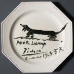 Souvenir luncheon plate painted by Pablo Picasso and dedicated to Lump, David Douglas Duncan's dachshund. Black glaze on commercial ceramic plate. 24 cm. in diameter. April 19th, 1957. Photo by Pete Smith. Image courtesy of Harry Ransom Center.