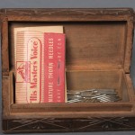 Carved wooden box containing two packs of “His Master’s Voice” thorn needles and loose steel needles, for use in a record player. Photo by Anthony Maddaloni.