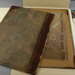 After the leather is consolidated, the original cover of the book is housed with the book in the same box.