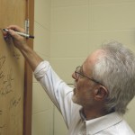 Coetzee signs the authors' door at the Ransom Center during a visit in May 2010.