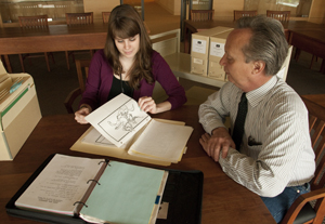 Archivist Carly Dearborn and Ransom Center Curator of Film Steve Wilson with materials from the Tom Smith collection. Photo by Pete Smith.