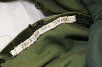 Label in the green curtain dress reading "Sprayed with Sudol." Photo by Anthony Maddaloni.