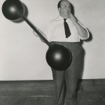 "Heavyweight in Light Mood" publicity still of Hitchcock toying with a prop on the set of “Rebecca.”