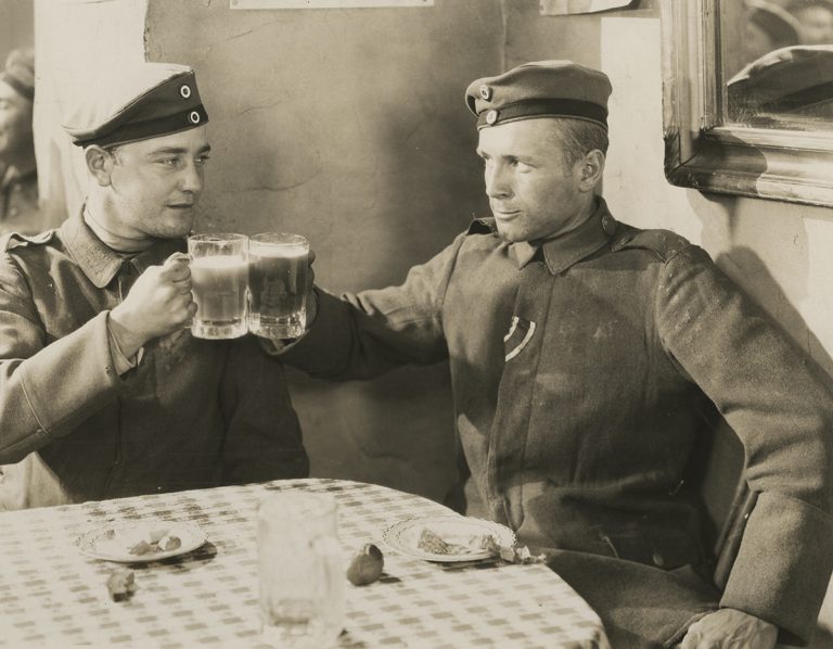 German soldiers enjoy a brief respite from trench duty in a film still from “All Quiet on the Western Front.”