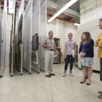 Watson leads a tour of new graduate interns through the Ransom Center's vertical storage space for art. Photo by Pete Smith.
