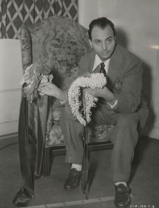 SIP publicity photo of John Frederics with two hats, 1939.