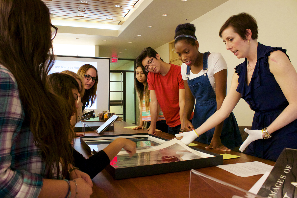 Teacher Andrea Gustavson shares photography materials with undergraduate students in her class "American Images: Photography, Literature, Archive" Photo by Robert V. Reichle.