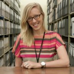 Undergraduate intern Kelsey McKinney standing among some of the Ransom Center's manuscript collections. Photo by Pete Smith. Image courtesy of Harry Ransom Center.