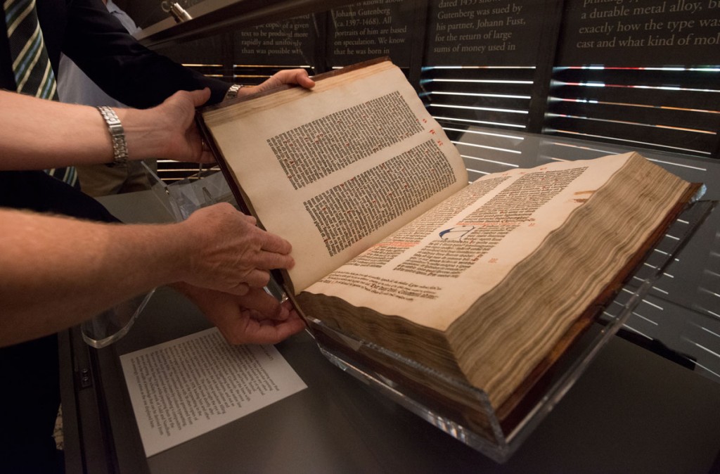 Conservators turn the pages to display the Book of Ezekiel in the Gutenberg Bible. Photo by Pete Smith.