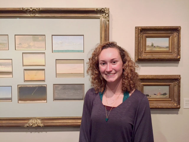 Isabella Savage in front of her favorite section of Frank Reaugh: Landscapes of Texas and the American West, "Studie and Sketches."