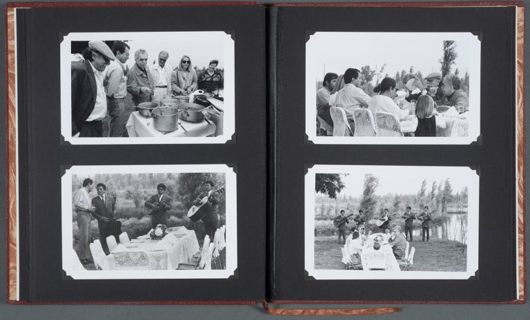 An album labeled "Un viaje de Xochimilco," opened to photographs of Gabriel García Márquez with author Carlos Fuentes and others, undated. Photographs by Fabrizio Leon.