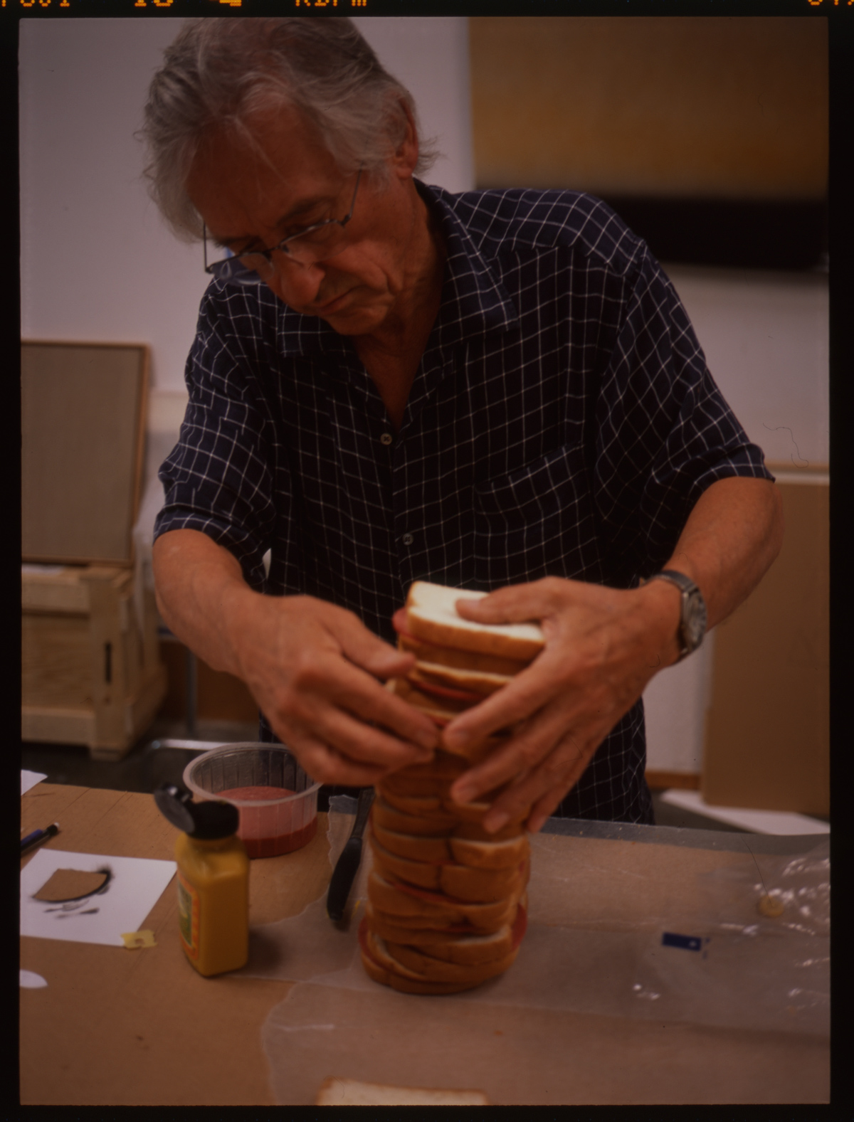 Ed Ruscha (American, b. 1937), Ed Ruscha making a sandwich to be photographed for his book On the Road: An Artist Book of the Classic Novel by Jack Kerouac, ca. 2008 or 2009. Color transparency, 4 x 5.6 cm. © Ed Ruscha. For Ruscha’s most recent book project, published in 2009, he created an illustrated version of Jack Kerouac’s seminal beat novel On the Road. The complete text of the novel is reproduced alongside photographs Ruscha made or selected from other sources. Several boxes of material document the process from conception to publication, and include contact sheets, negatives, and transparencies for all the images from the book that Ruscha made himself (including this sandwich), as well as a few that didn’t make the cut.