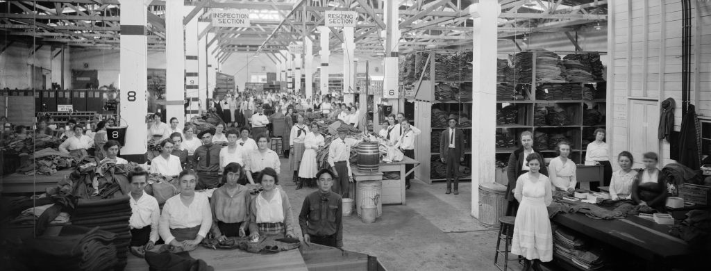 Attributed to C. A. Stead (American, 1870-1932), QMC Personnel Working on Army Clothing at a Supply Depot, ca. 1919. Digital positive from nitrate negative, 20 x 50.4 cm. E. O. Goldbeck Papers and Photography Collection, 967:0068:0887