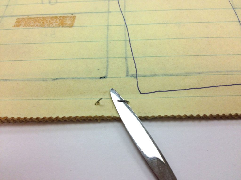 Opening staples with a spatula.