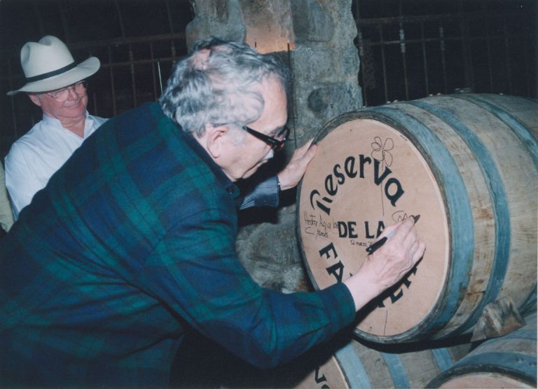 Gabriel García Márquez autographing a wine barrel, 2005. Photographer unknown.