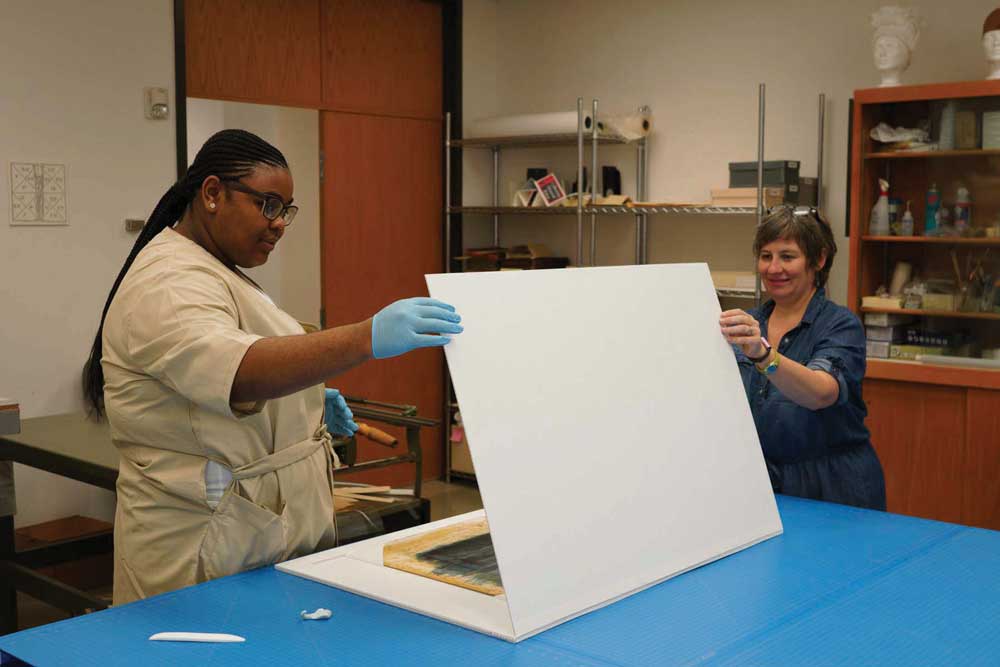 Preservation technician Genevieve Pierce and I work on sink mats for storyboards from the David O. Selznick collection.