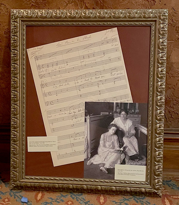 Framed display of sheet music and a photograph