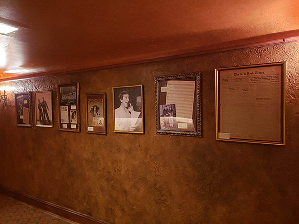 Framed photographs and historical items on a wall